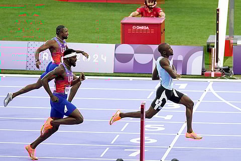 Letsile Tebogo crosses the finish line followed by Kenneth Bednarek, center, and Noah Lyles